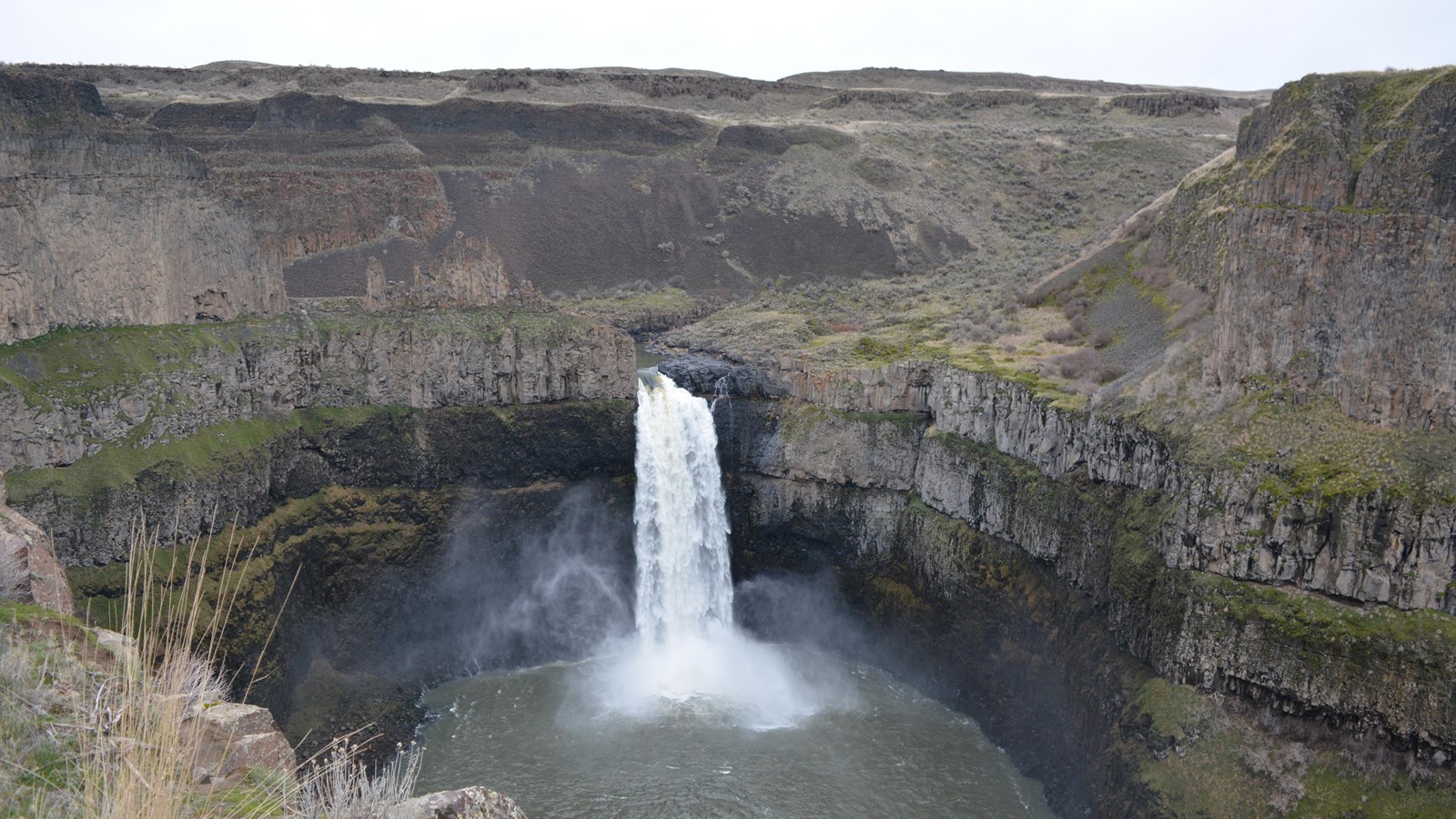 Image of cascading water into a huge basin pond or lake some 400 feet below. 