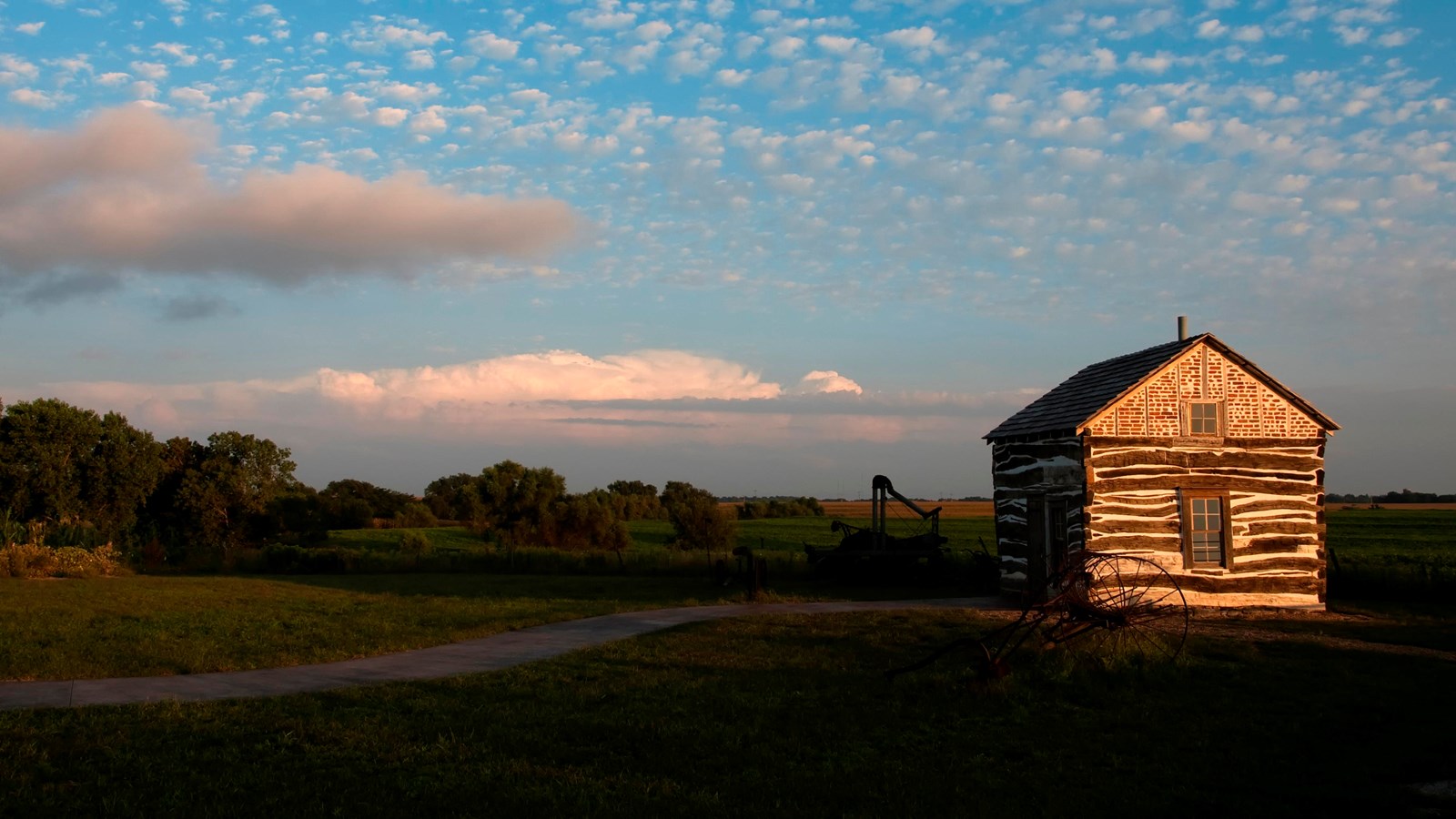 A wooden cabin stands on the plains.