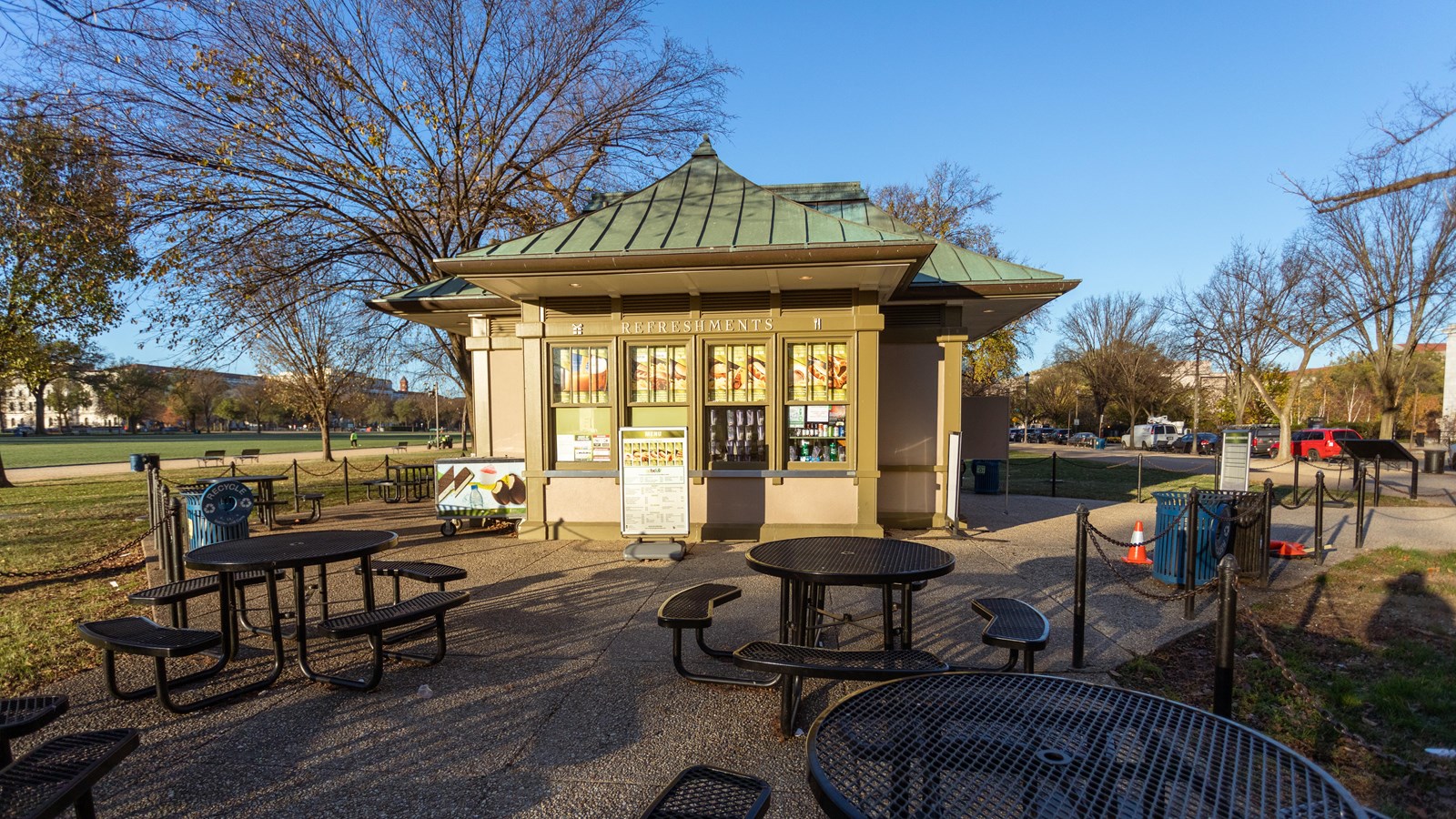 A smattering of picnic tables around a concession stand.