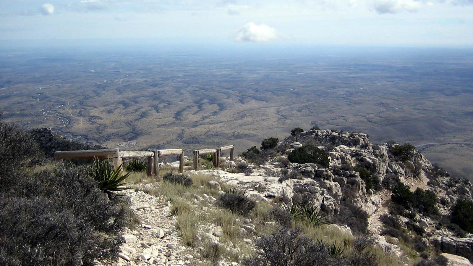 Wooden hitching posts for stock on a high desert mountain peak.