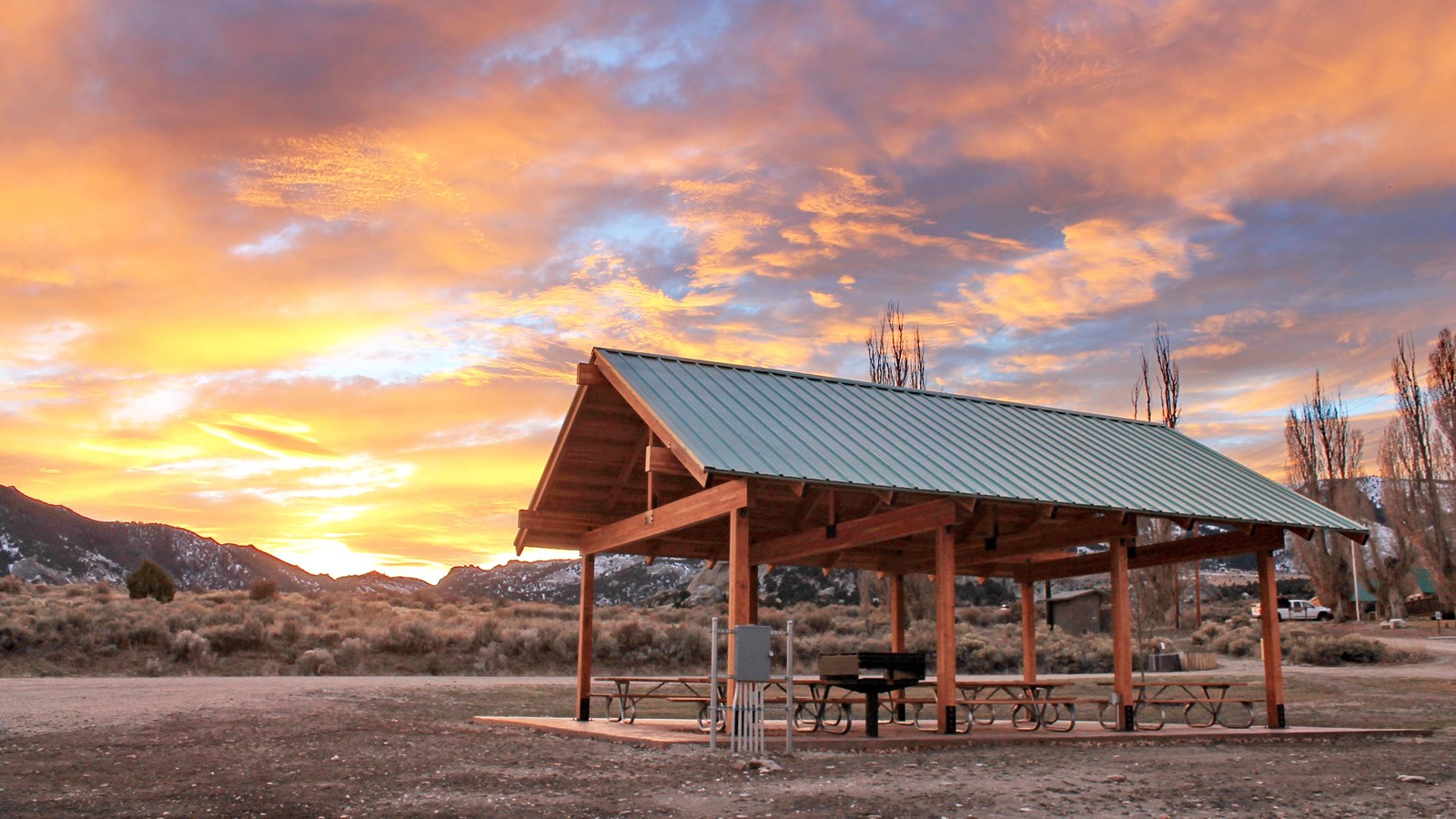 The picnic shelter with a dazzling sunset in the background.