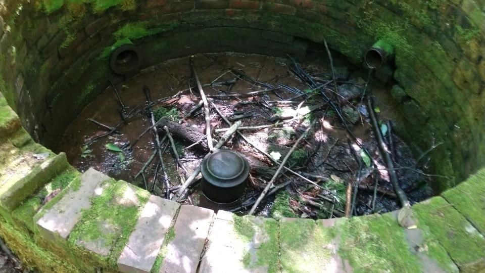 A circle of stone pavers resembling a low, shallow well.