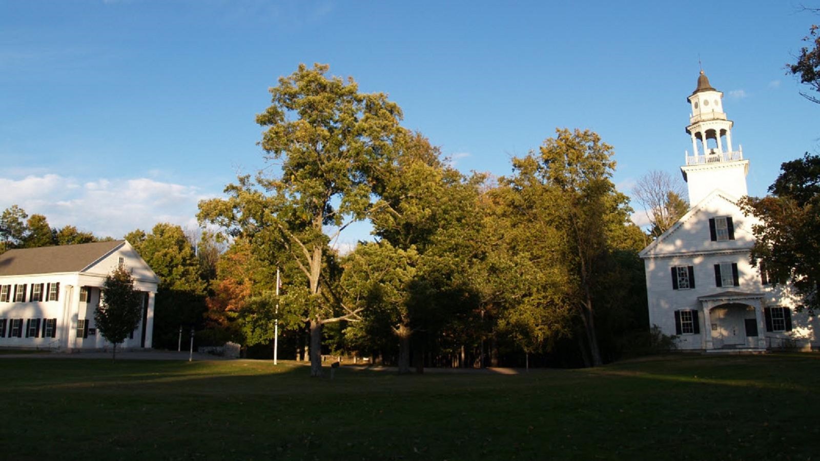 Photo of white church with steeple. 