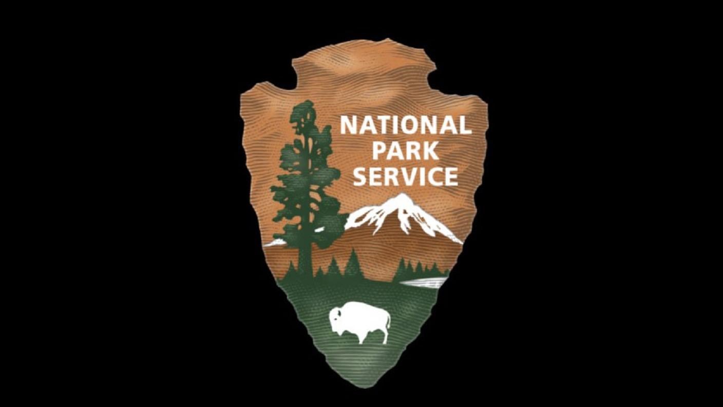 National Park Service arrowhead against a black background