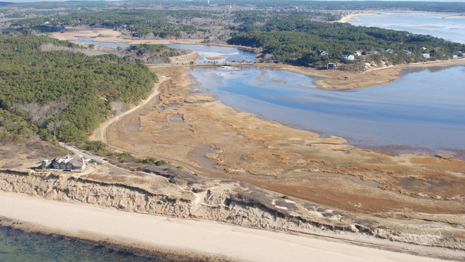 Aerial view of the start of the Great Island Trail, beach surrounded by ocean and a cove.