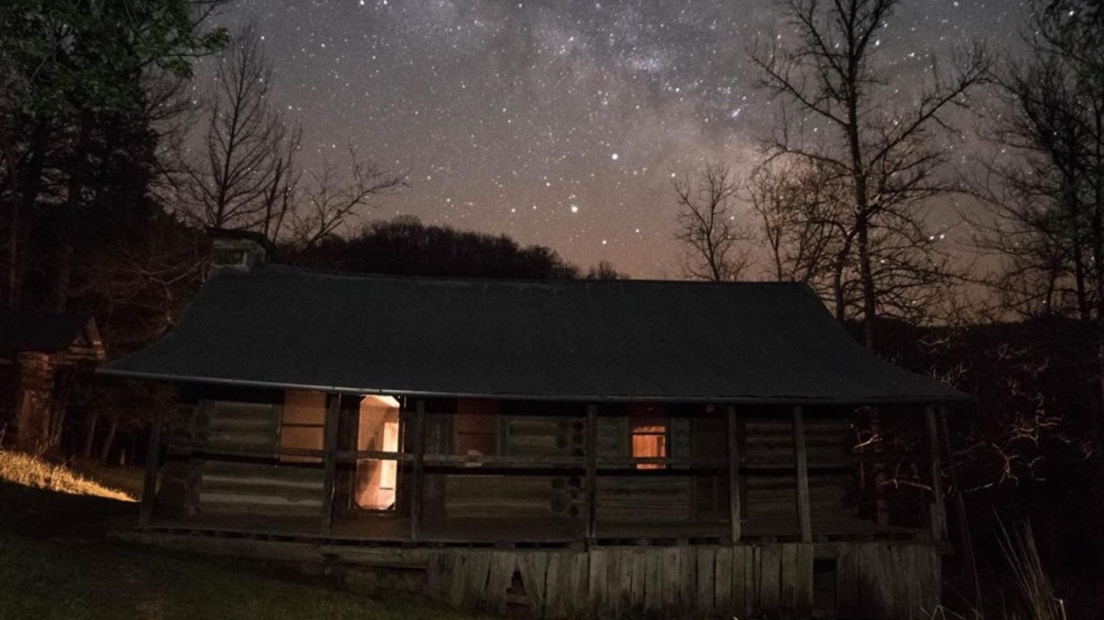 Beaver Jim Villines\' cabin with a starry night sky above. 