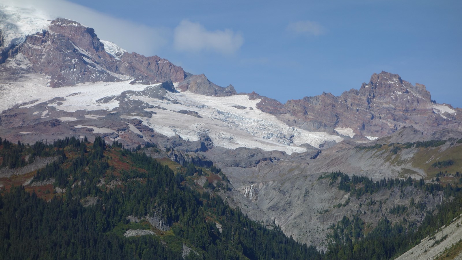 Large waterfall with glacier above it