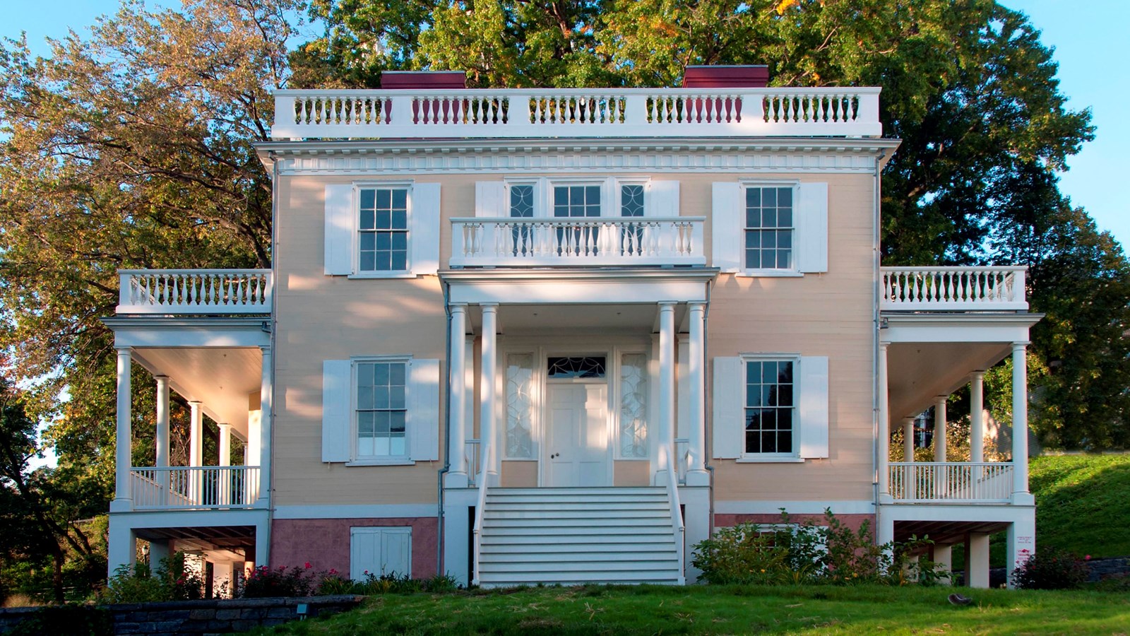 A yellow house with symmetrical features.