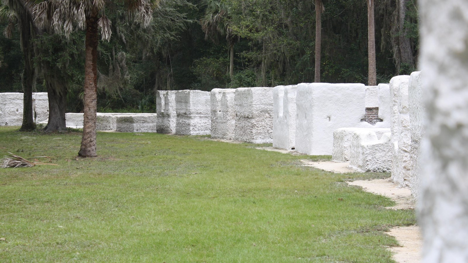 an arch of white roofless buildings