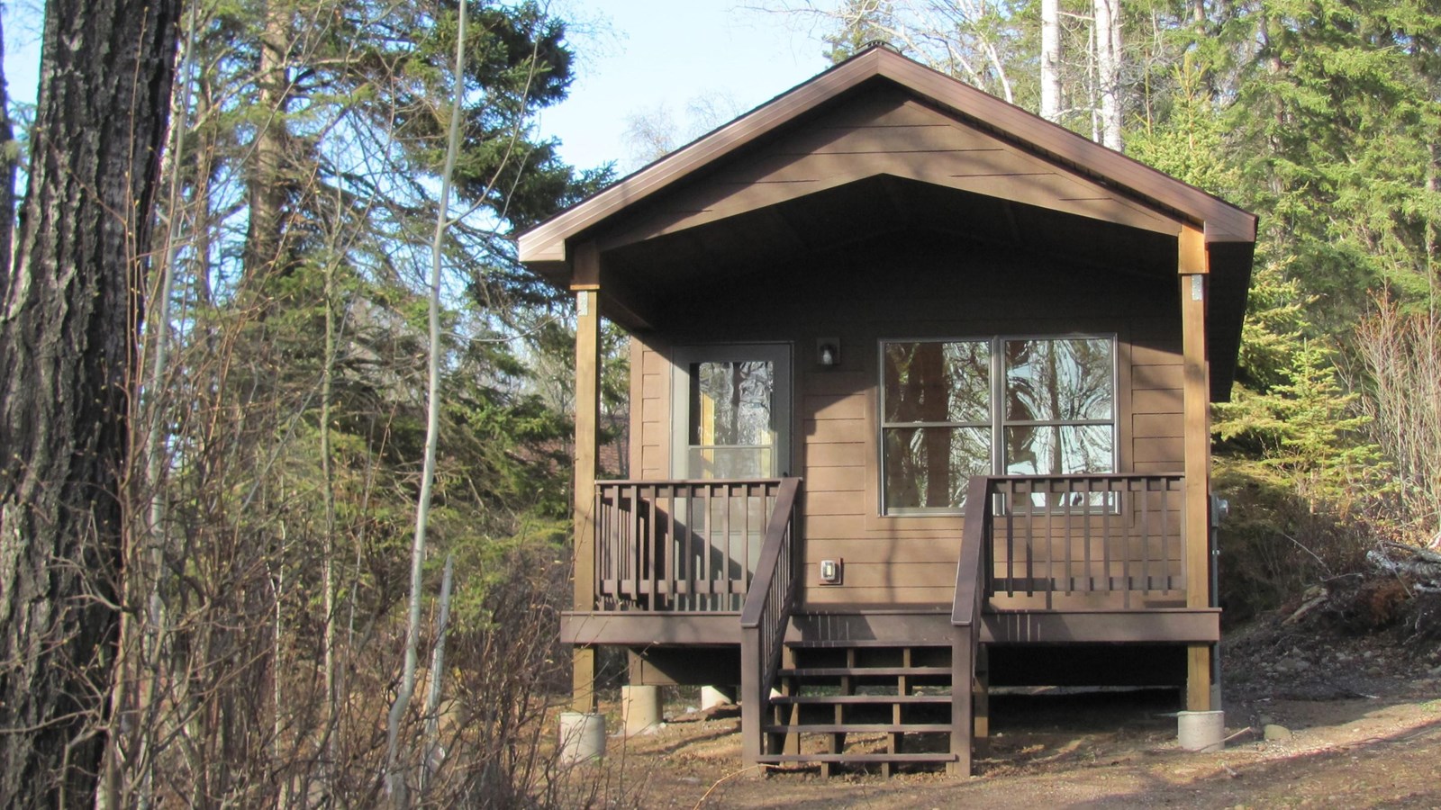A rustic cabin sits on top of a forested hill in Windigo on the west end of Isle Royale. 