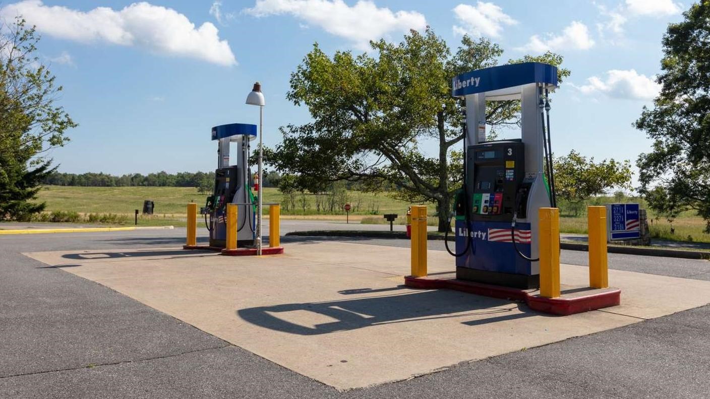 A color photograph of two gas pumps along the side of the road. 