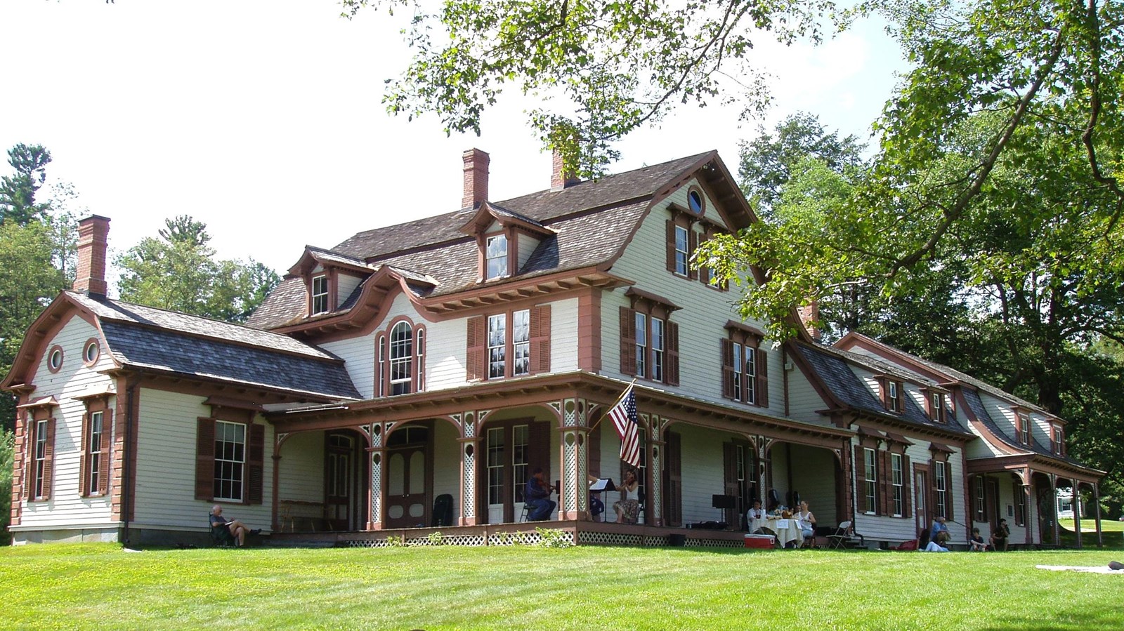 Photo of large two-story house with green lawn. 