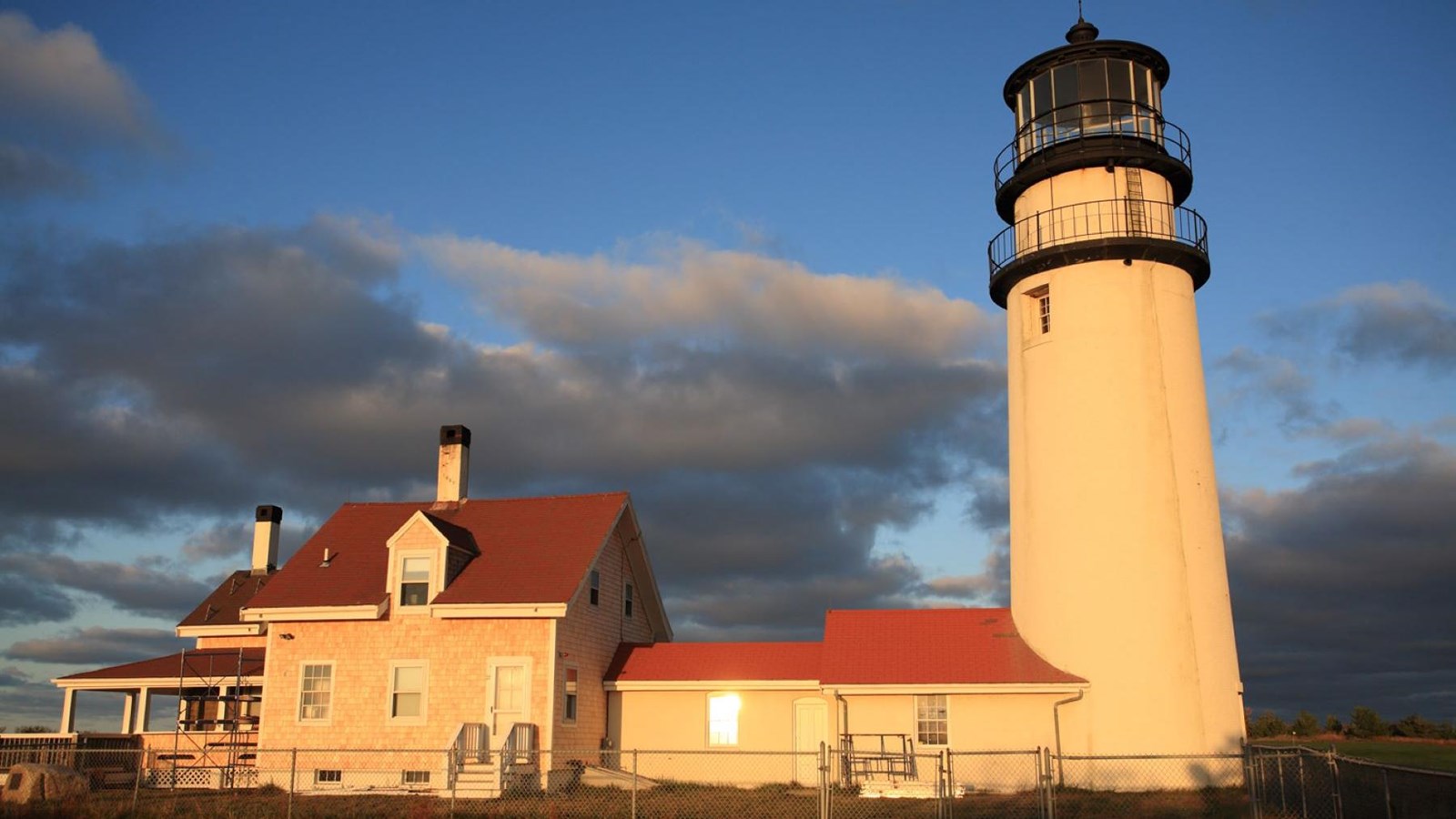 Image of Highland Light. The keepers house is connected next to the lighthouse.