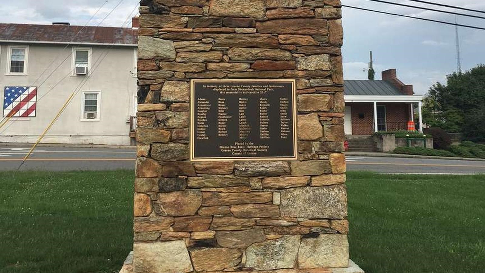 A stone chimney with a bronze plaque.