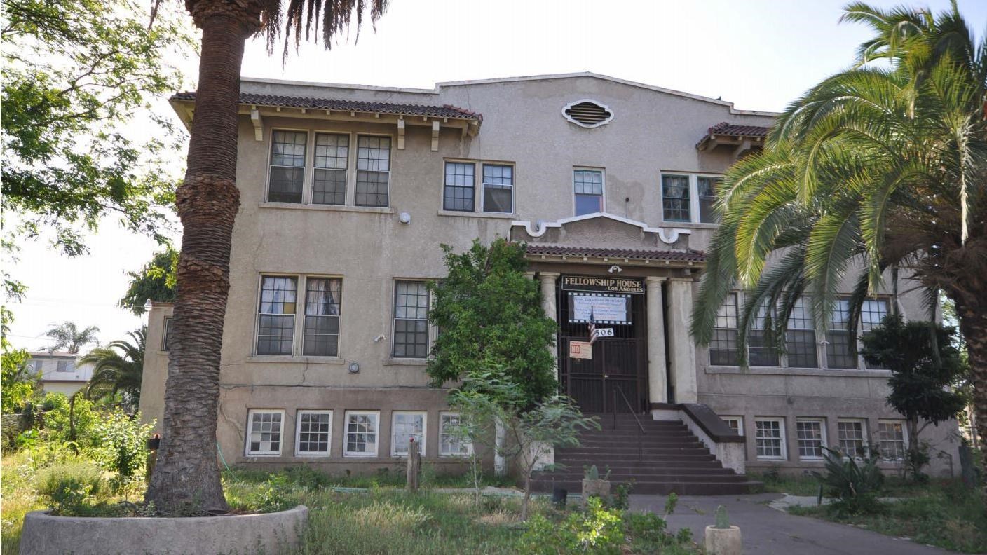 three story building with steps leading to the second story front entrance