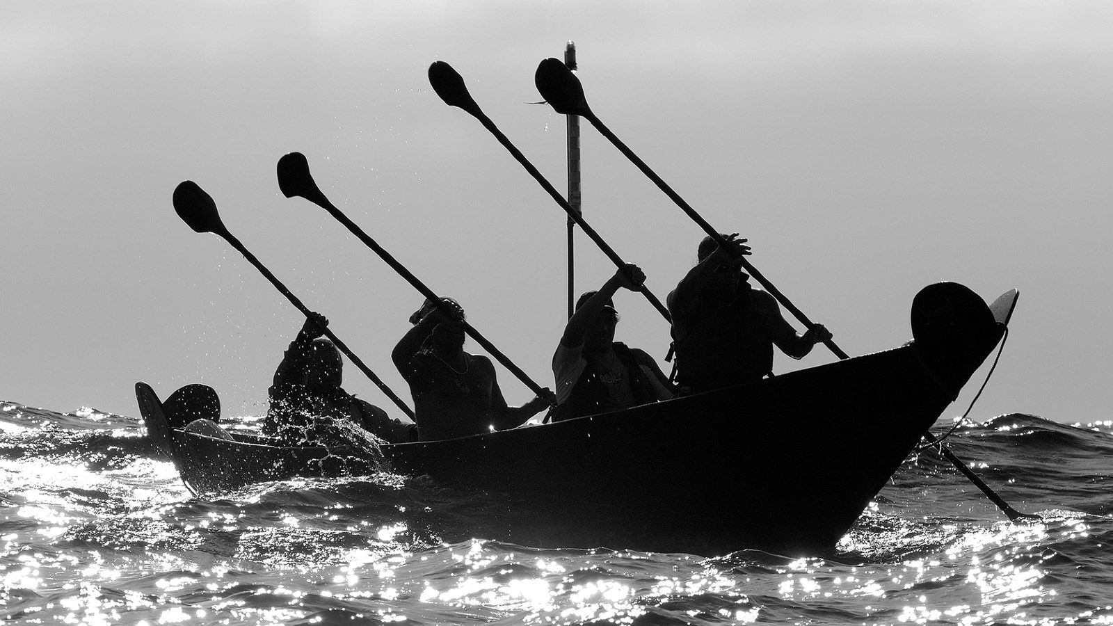 Chumash paddling a canoe shaped boat