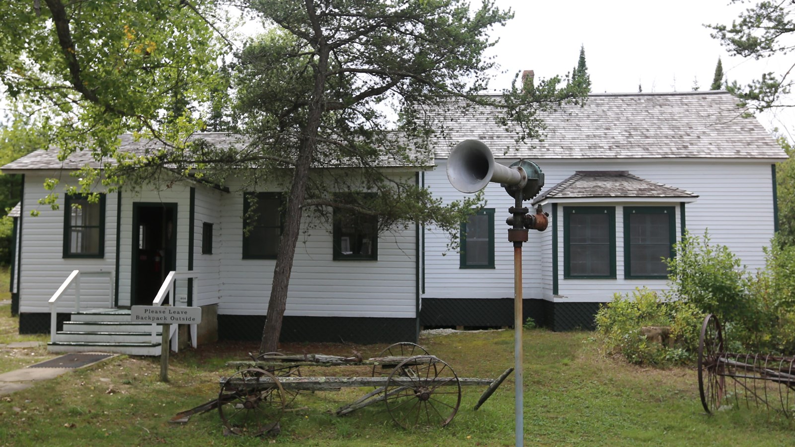 The island visitor center, a one-story, white clapboard building with several black-shingled gables