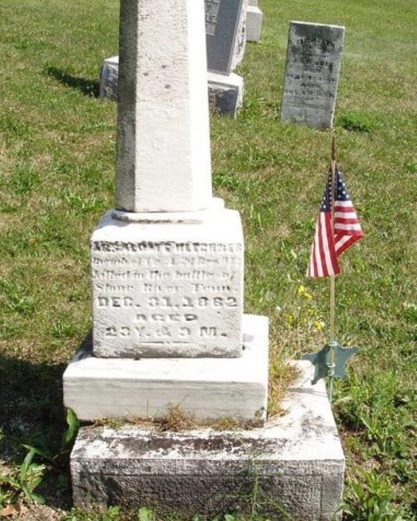 Tall, white headstone with writing on the base belonging to Civil War veteran Absalom. 