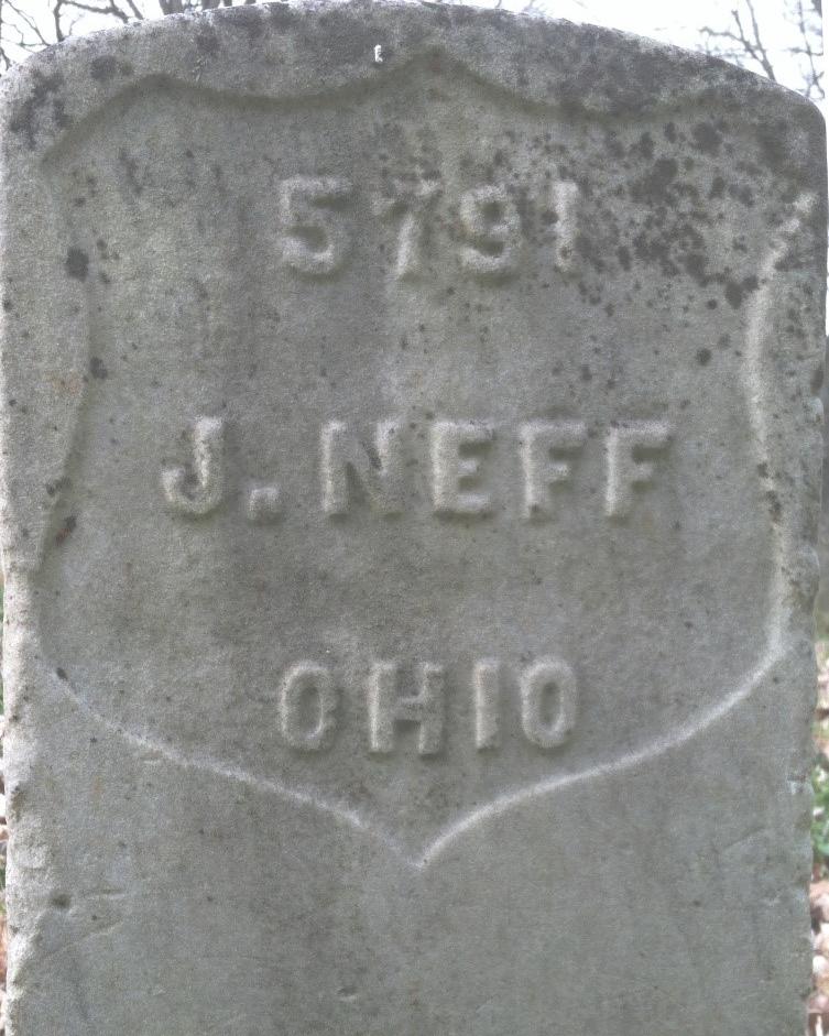 Greyscale photo with a headstone that reads "J. Neff."