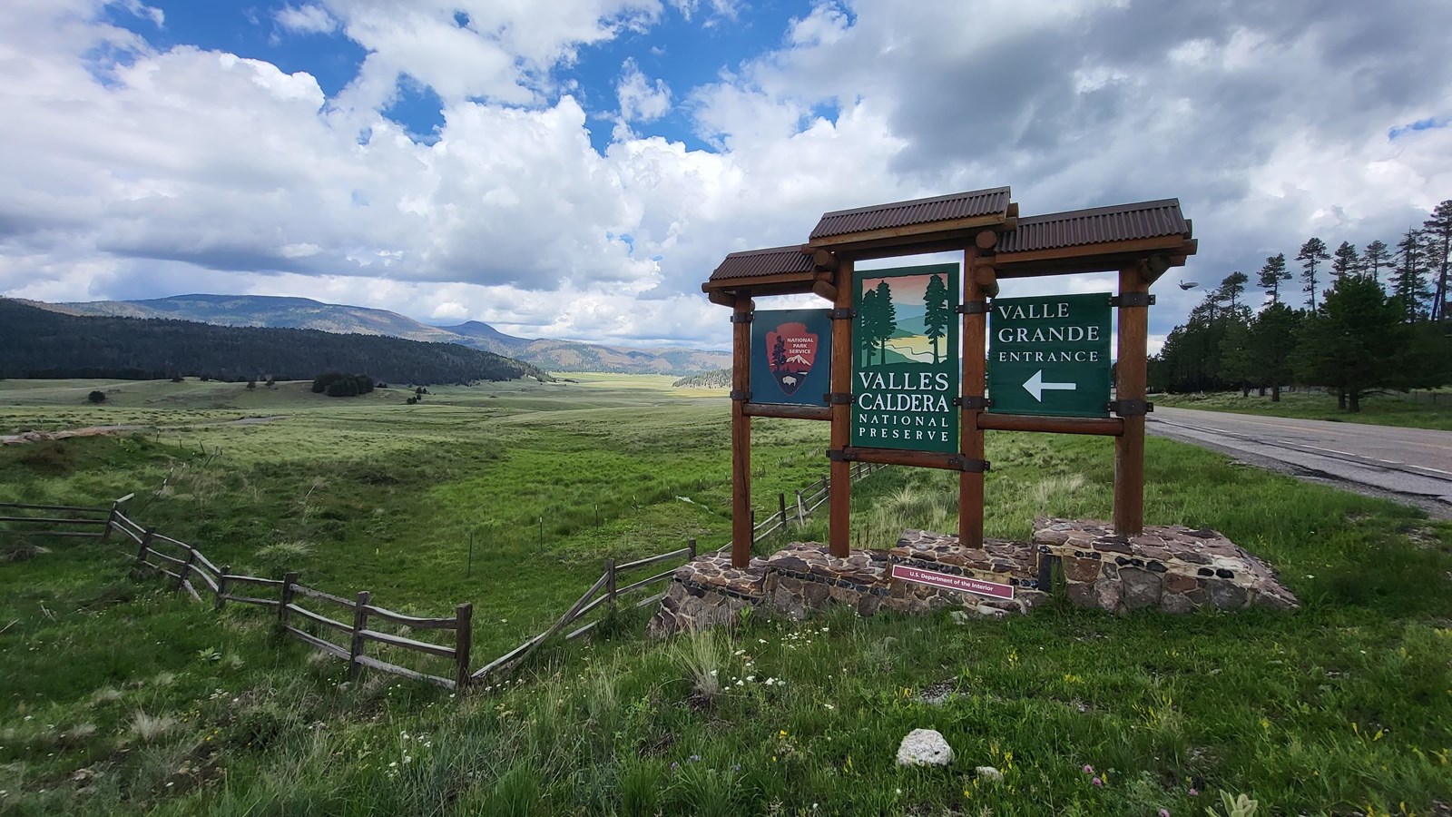 The Valles Caldera National Preserve entrance sign with a vast grassland behind it.