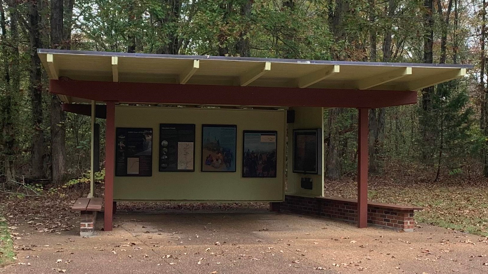 Exhibit shelter with info panels on back wall. fourth panel on right is about trail of tears