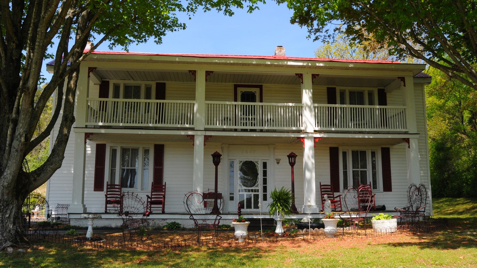 A large white house with a double porch.