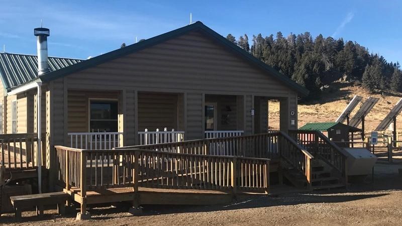 A tan, single-story building with a wheelchair ramp in the front.
