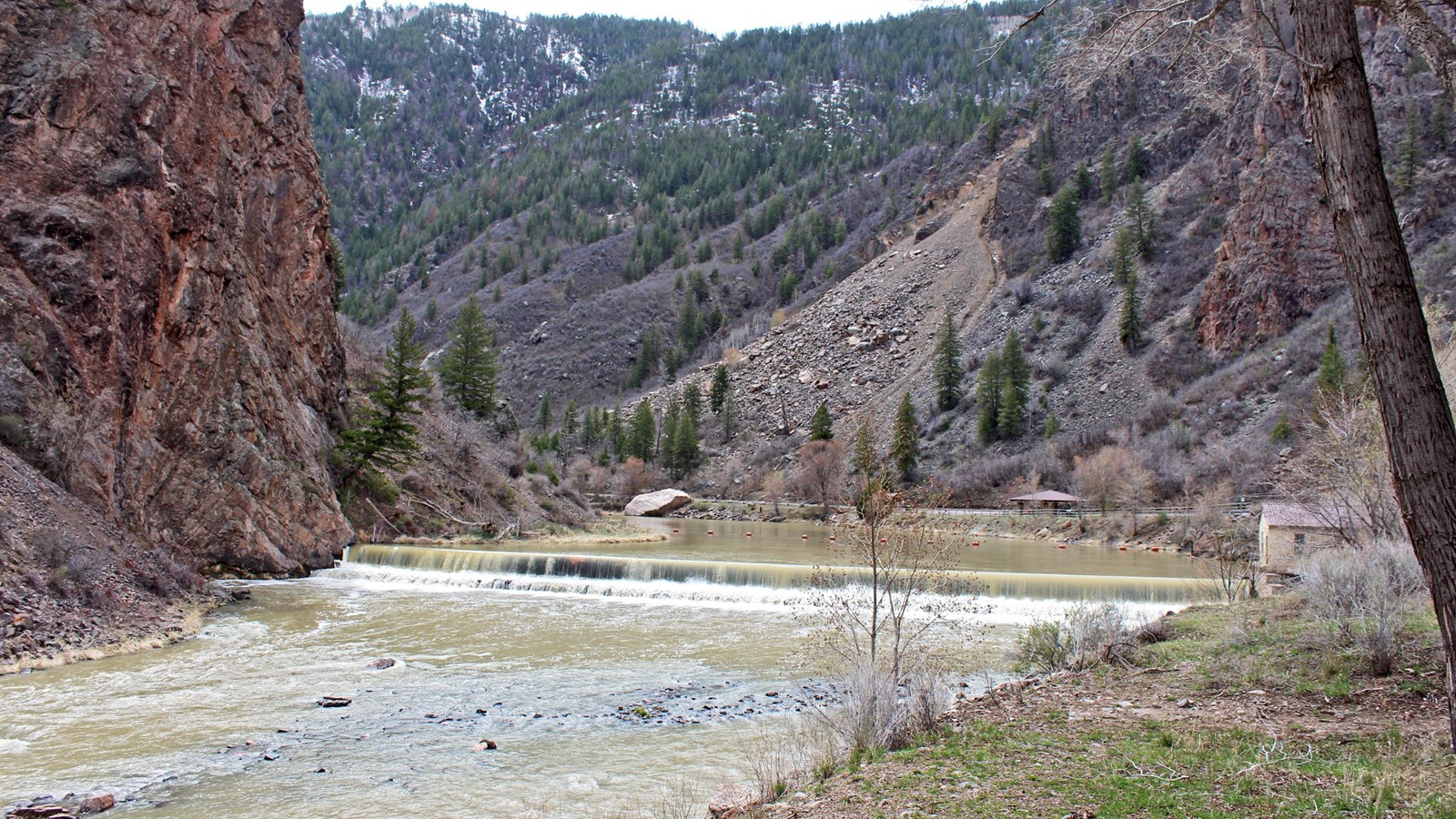 A river and dam between two tall canyon walls