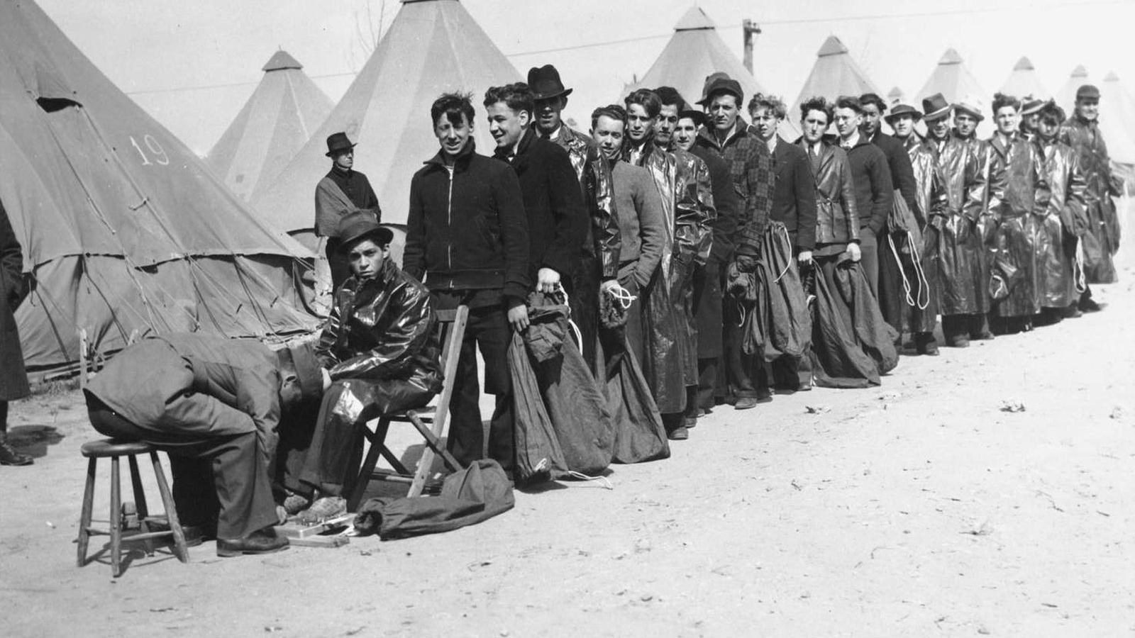 New recruits to a CCC camp wait in line.