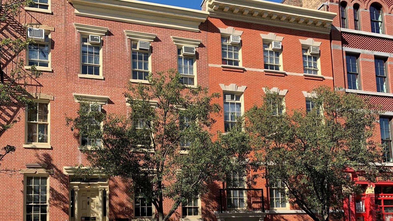 Three story brick building on city street