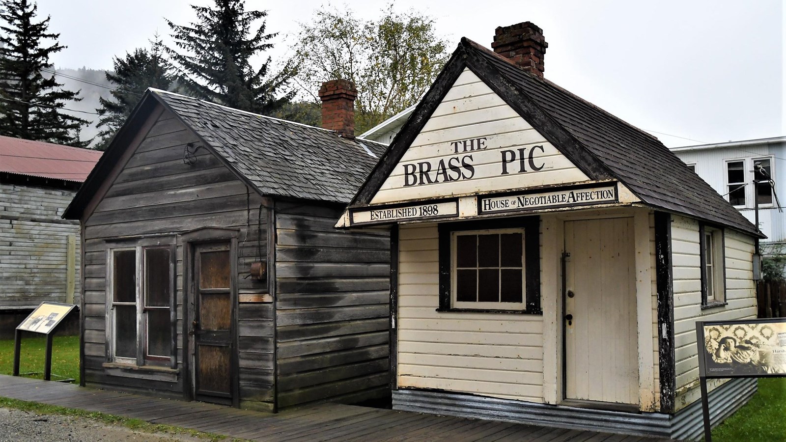 Two small wooden one-story buildings stand side-by-side.
