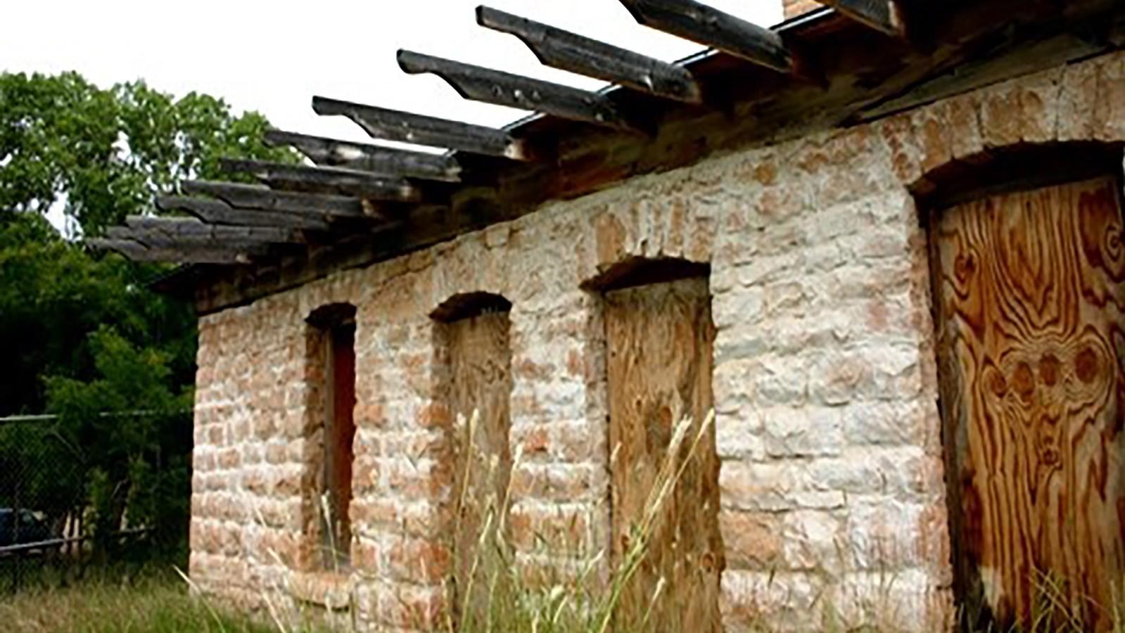 The McBride House made of limestone, dolomite, and railroad ties.  The roof is flat. 