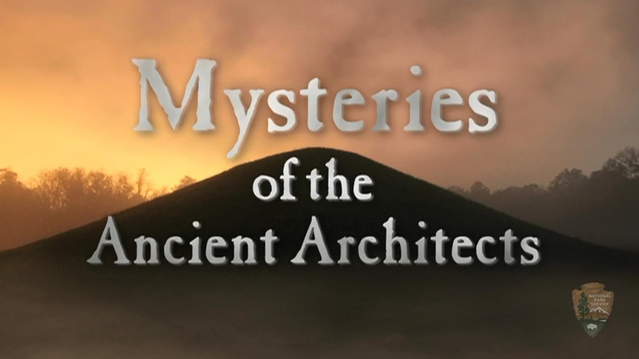 Film title screenshot with mound in background, text reads Mysteries of the Ancient Architects