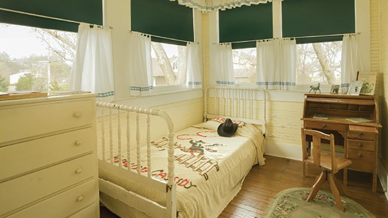Young Bill Clinton\'s bedroom includes a replica rolltop desk, bed with Hopalong Cassidy blanket and