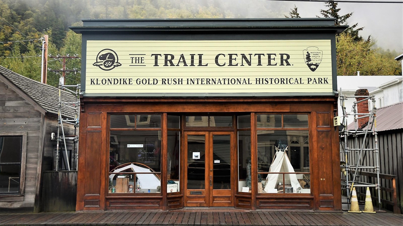 Wood and glass building with large sign that reads 
