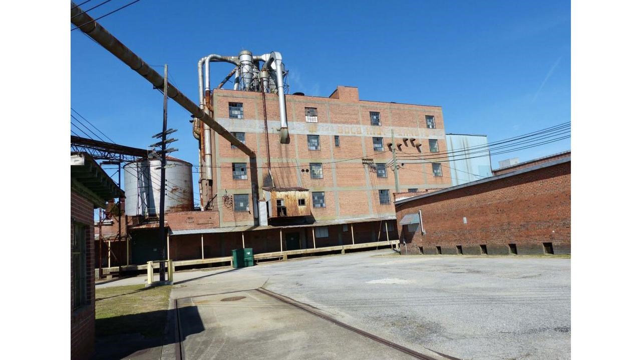 factory building with an empty parking lot in the front view