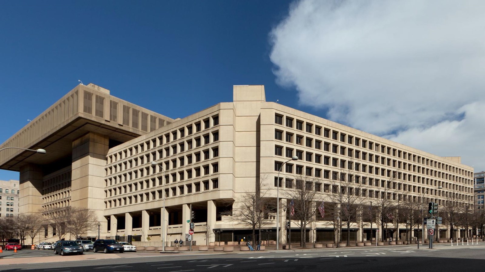 FBI Headquarters, a low rise building of poured concrete with rows with raised penthouse on left 