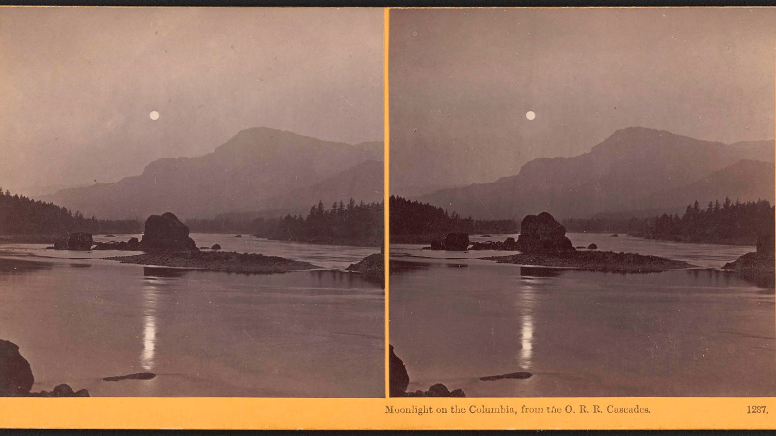 Black and white photo of the Columbia River under a full moon.