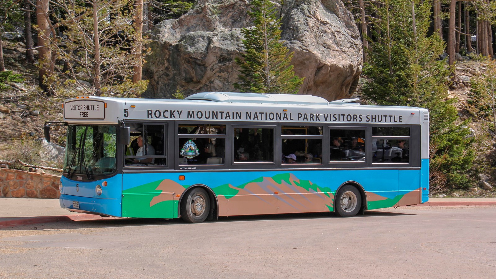 One of the park\'s shuttle buses is driving on Bear Lake Road