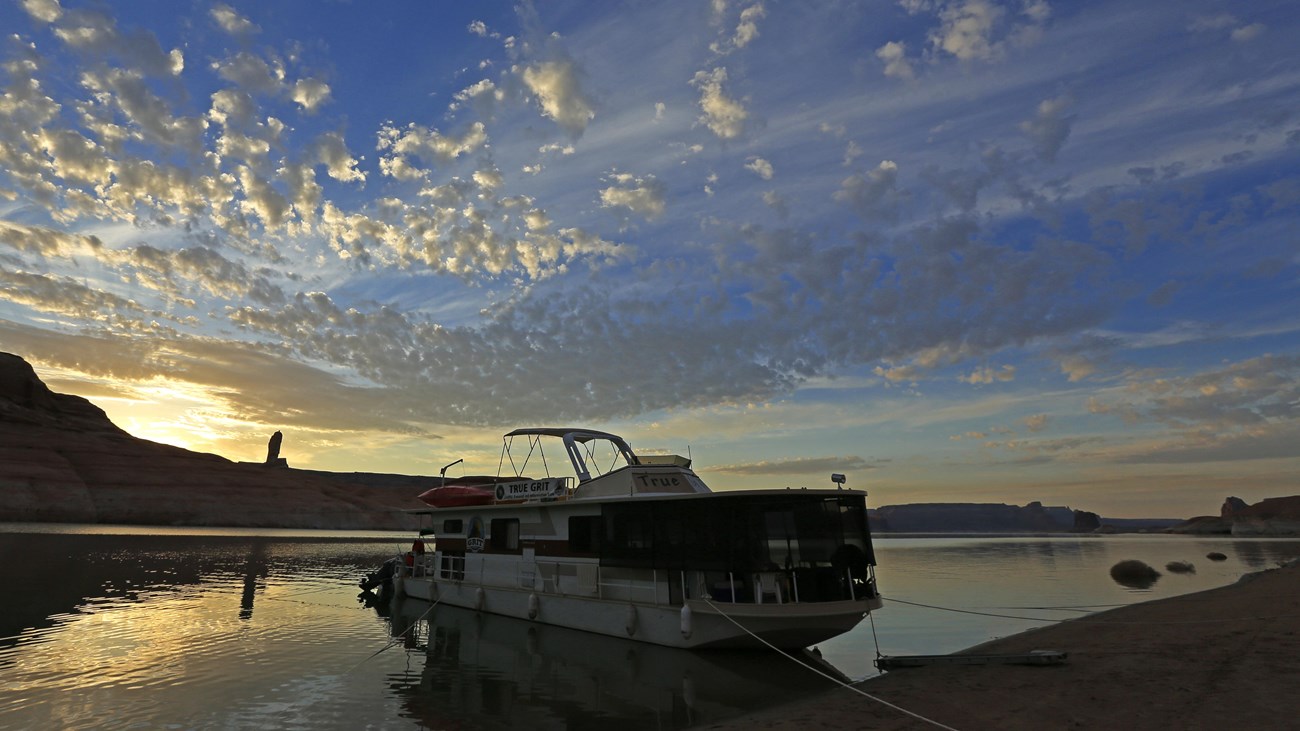 houseboat beached on lakeshore at dawn