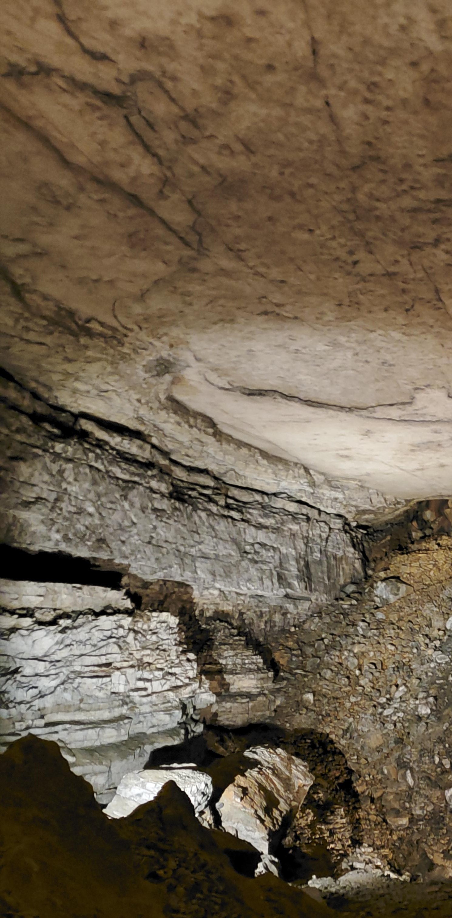 A large hill of broken rocks inside a cave passage.