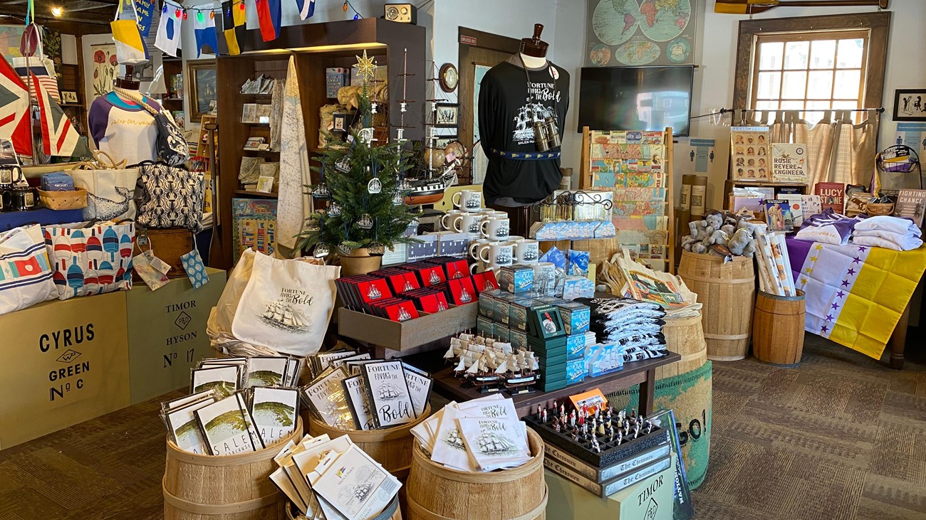 books, apparel, toys, maps and other souvenirs on display inside a store