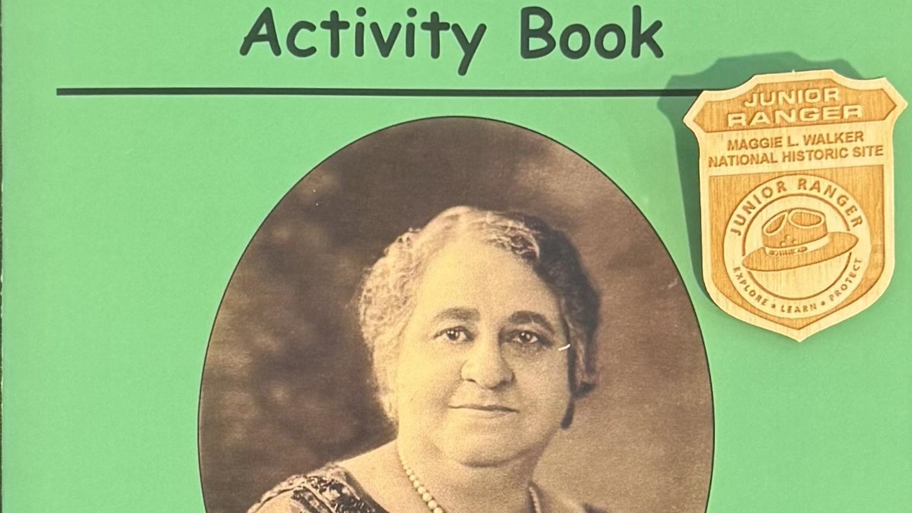 Cover of green and black booklet with a wooden badge on top