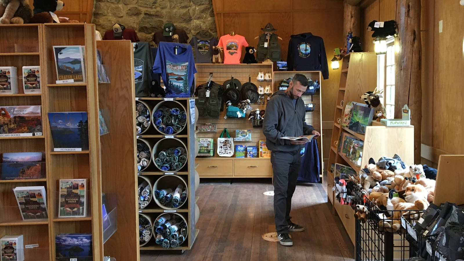 A visitor peruses the shelves of merchandise in the park store.