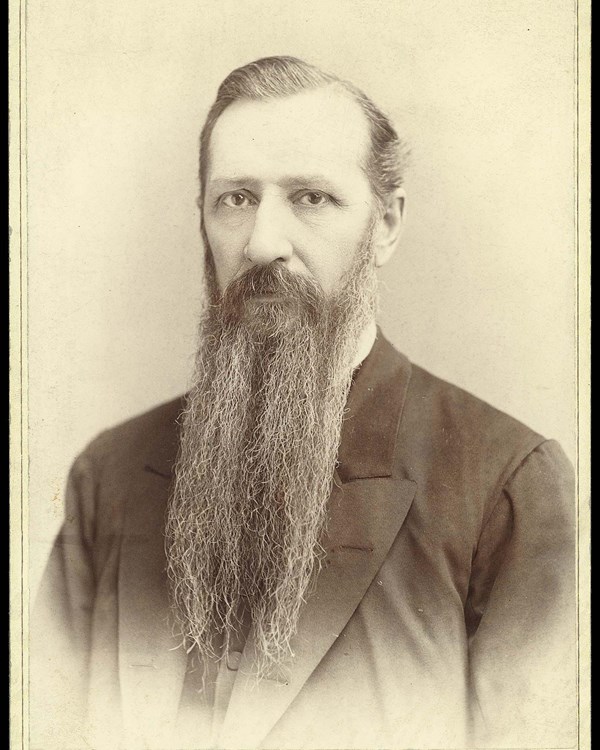  A bust portrait of a man with a full beard. 
