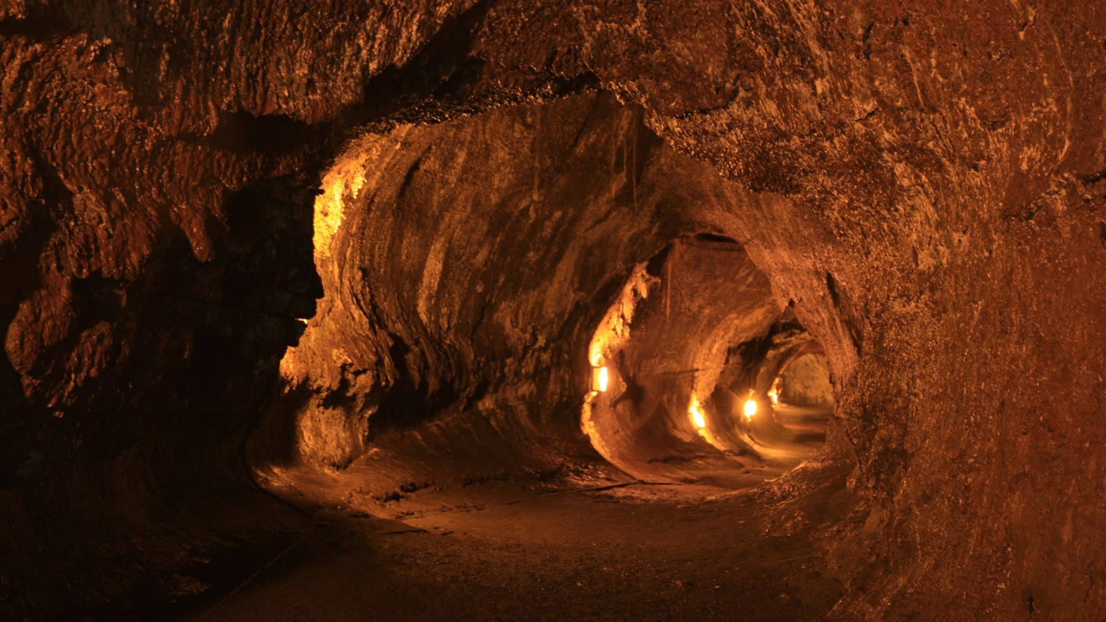 A lava tube lit by orange electric light