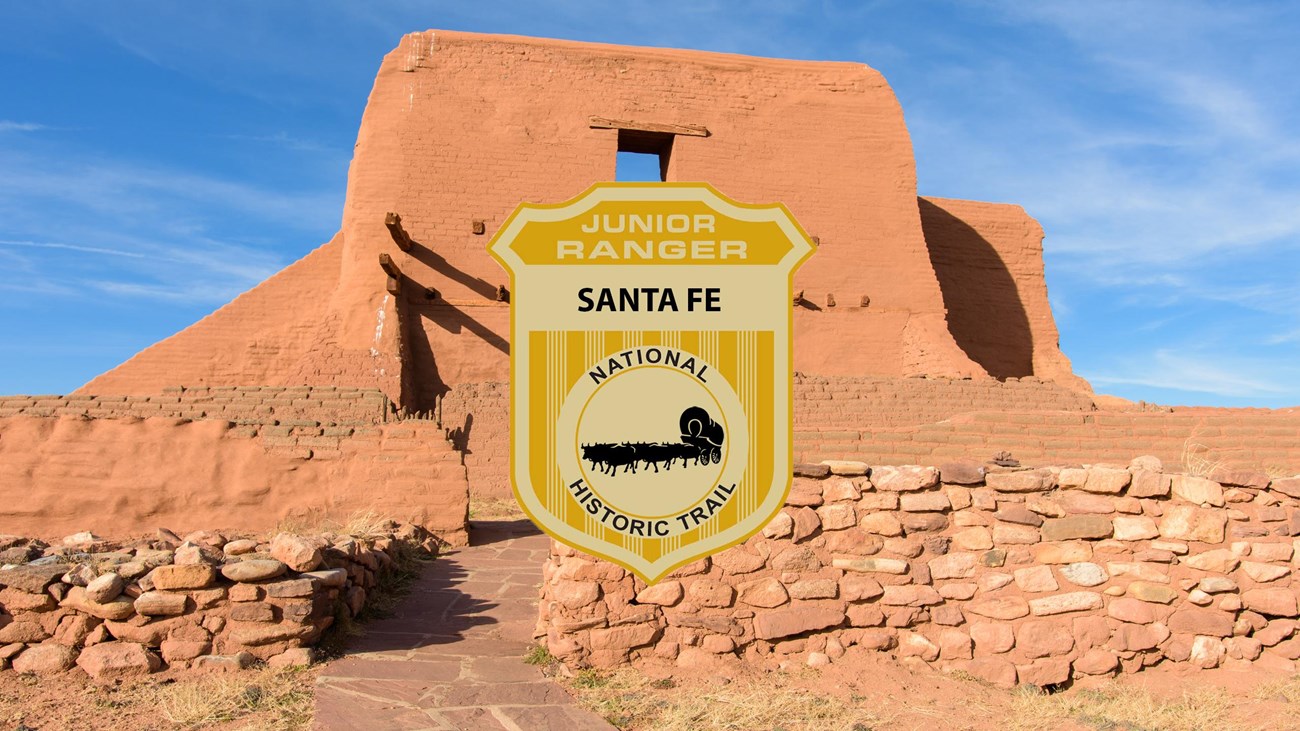 A junior ranger badge over the picture of a ruined adobe mission.