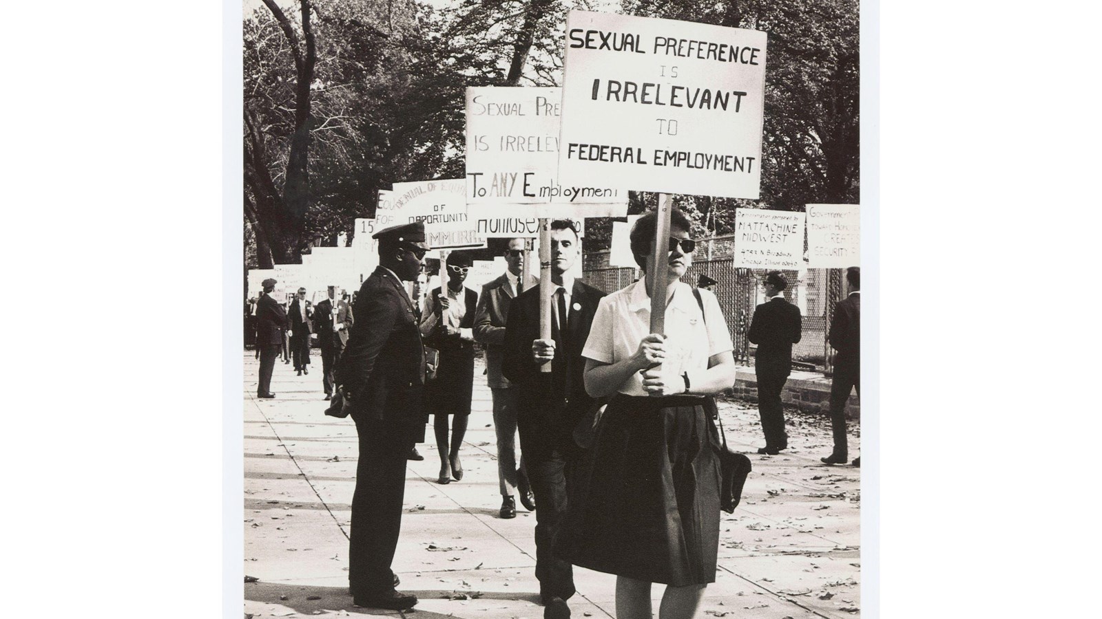 A line of people picketing at the White House, with signs advocating for gay rights
