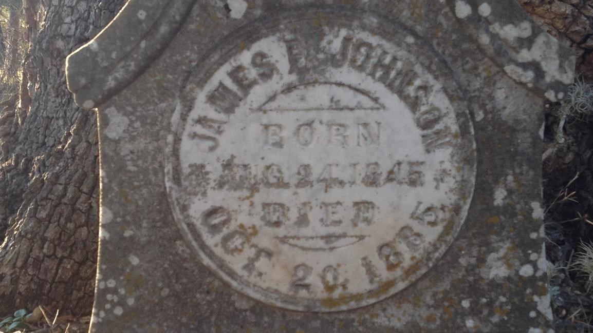 Dark gray stone marker has text 