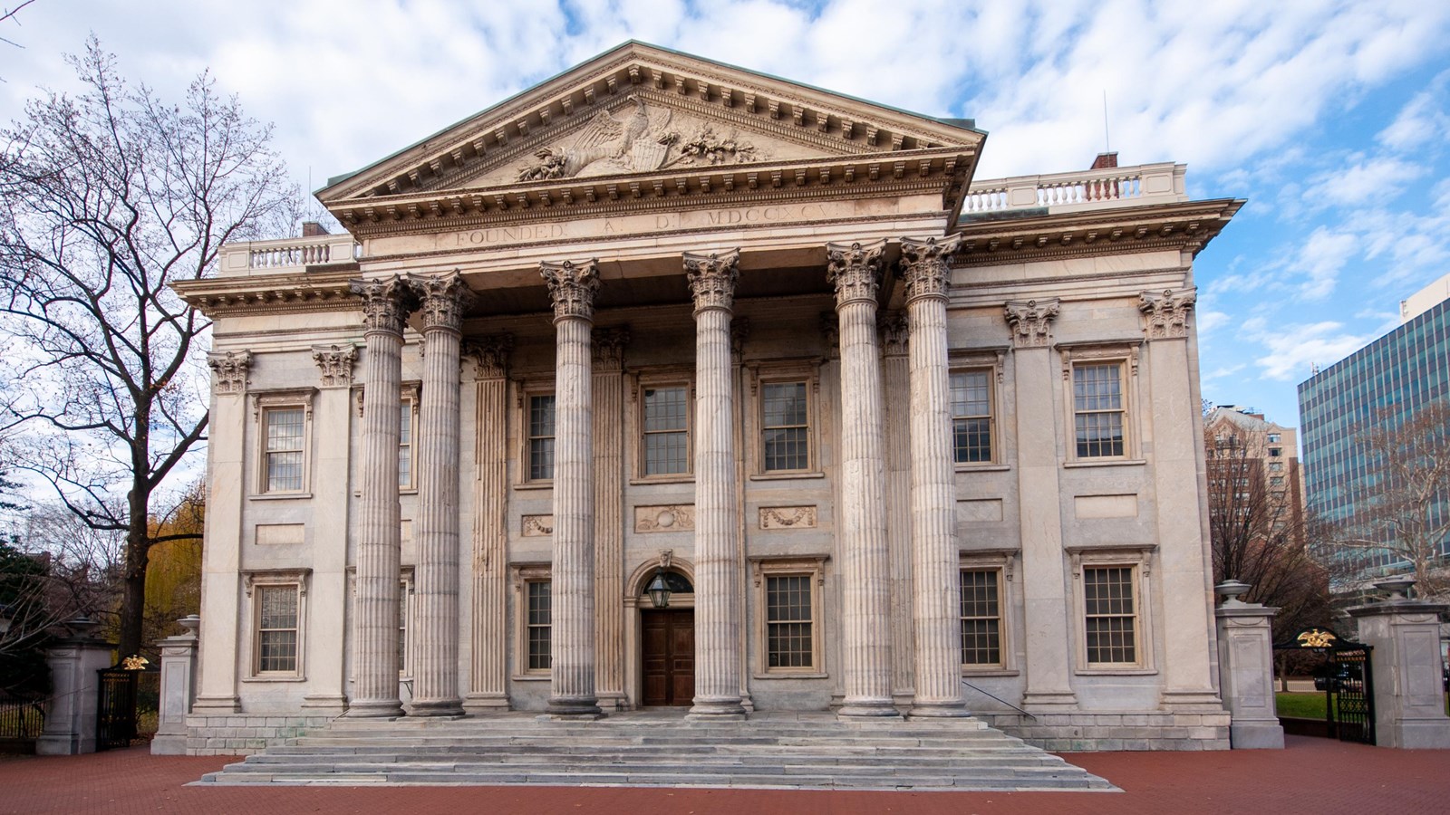A color photo of a two-story marble building with multiple columns supporting a triangular pediment.